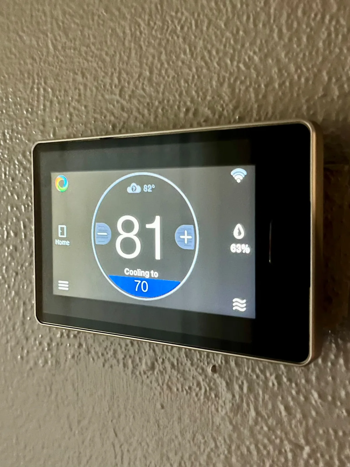 Touchscreen HVAC thermostat showing cooling settings