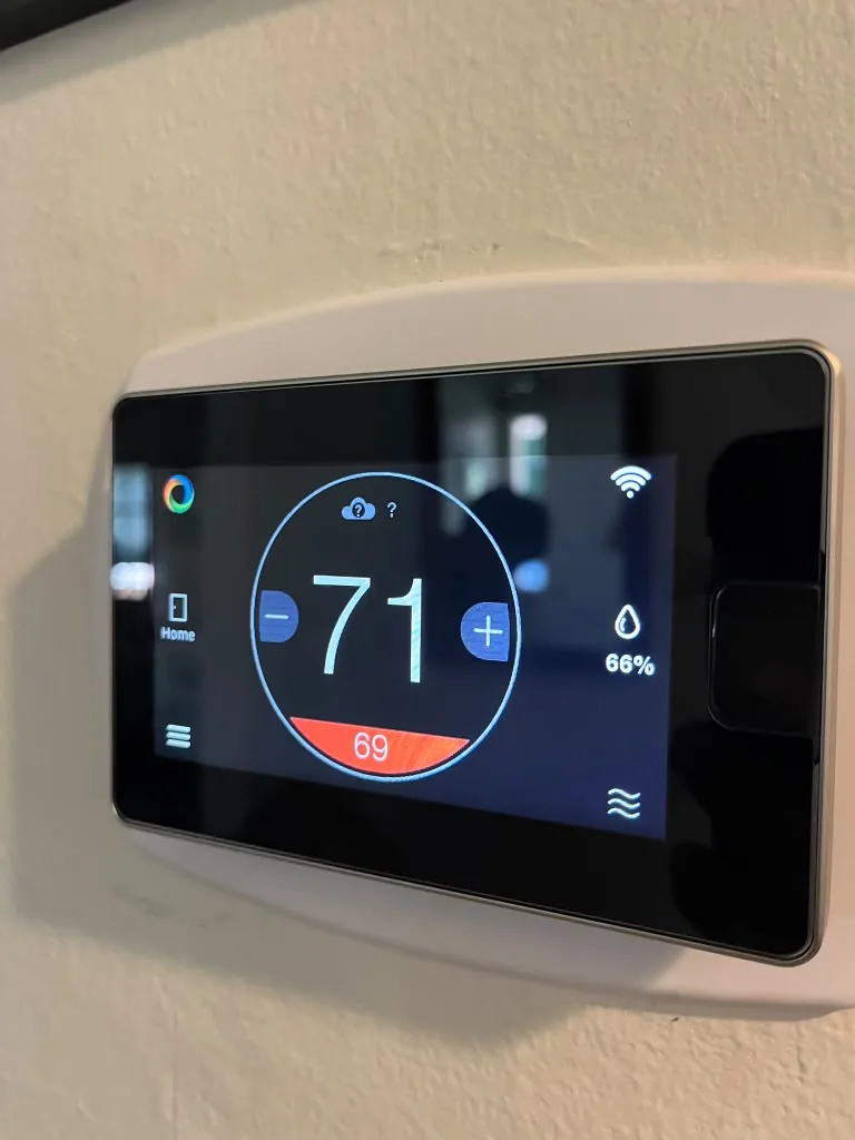 Wi-Fi touchscreen thermostat showing room temperature and settings