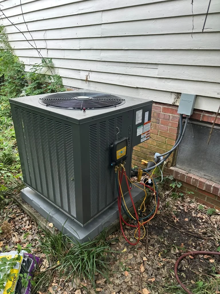 Outdoor HVAC equipment beside a home with siding
